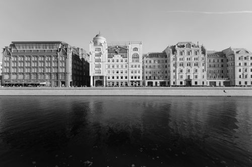 Free Elegant black and white cityscape with classic architecture along a waterfront. Stock Photo