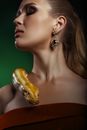 Beautiful Woman in Red Dress with Yellow Snake on Her Shoulder