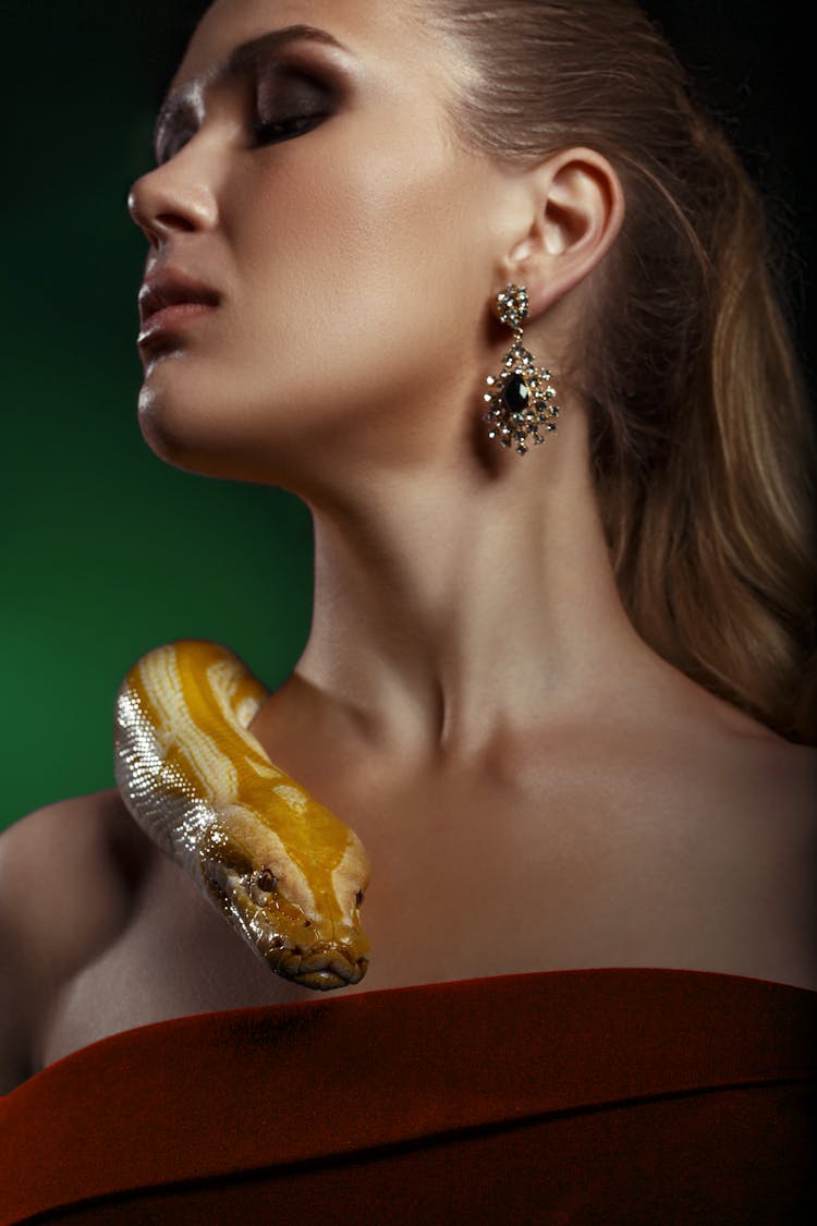 Beautiful Woman In Red Dress With Yellow Snake On Her Shoulder