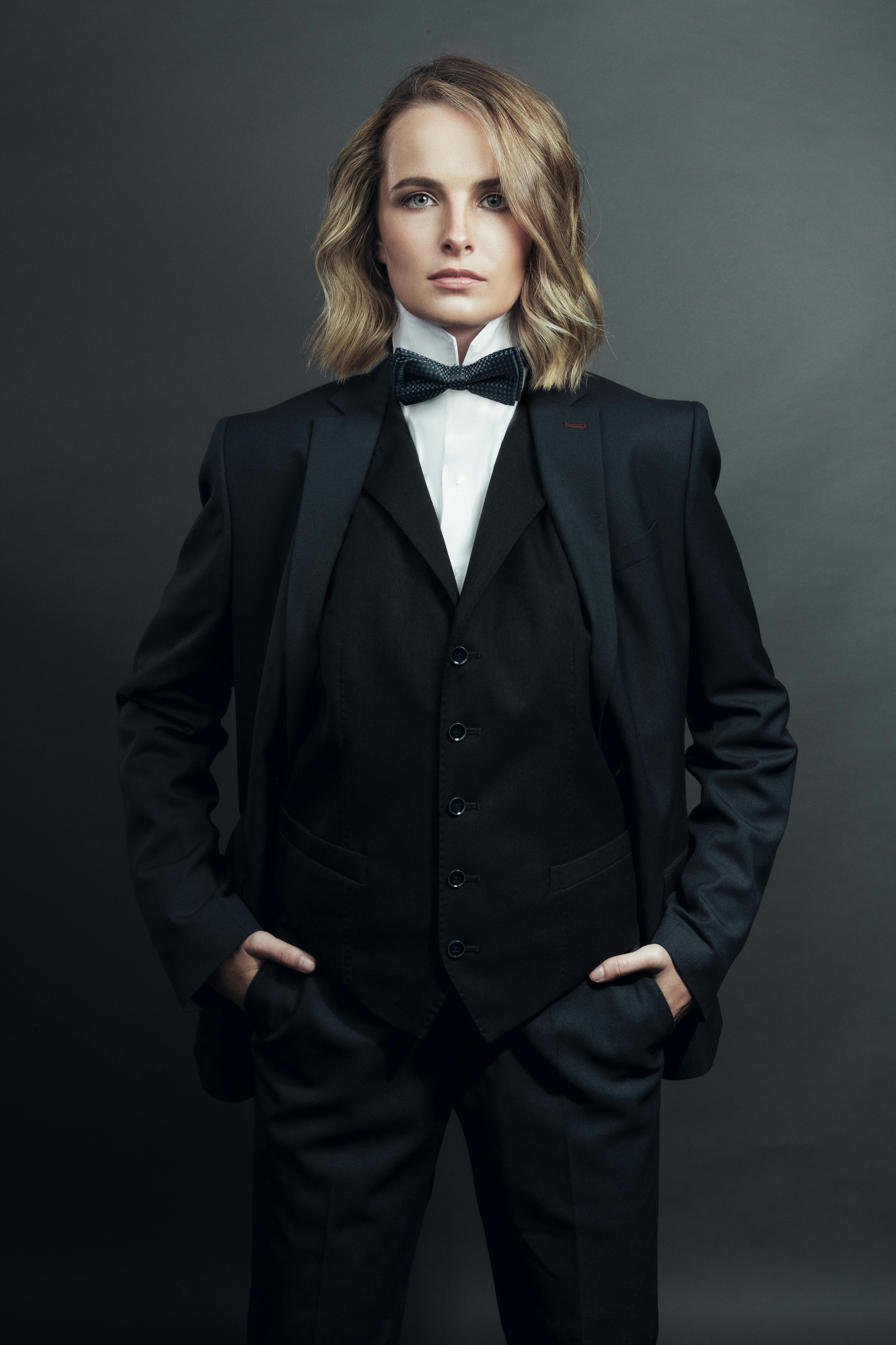 blond woman with long hair wearing tuxedo