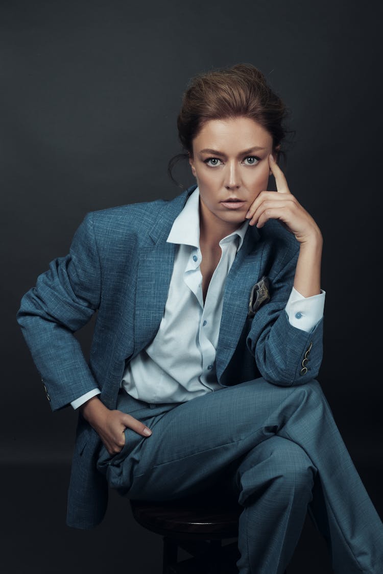 Business Woman Sitting On Stool With Legs Crossed 