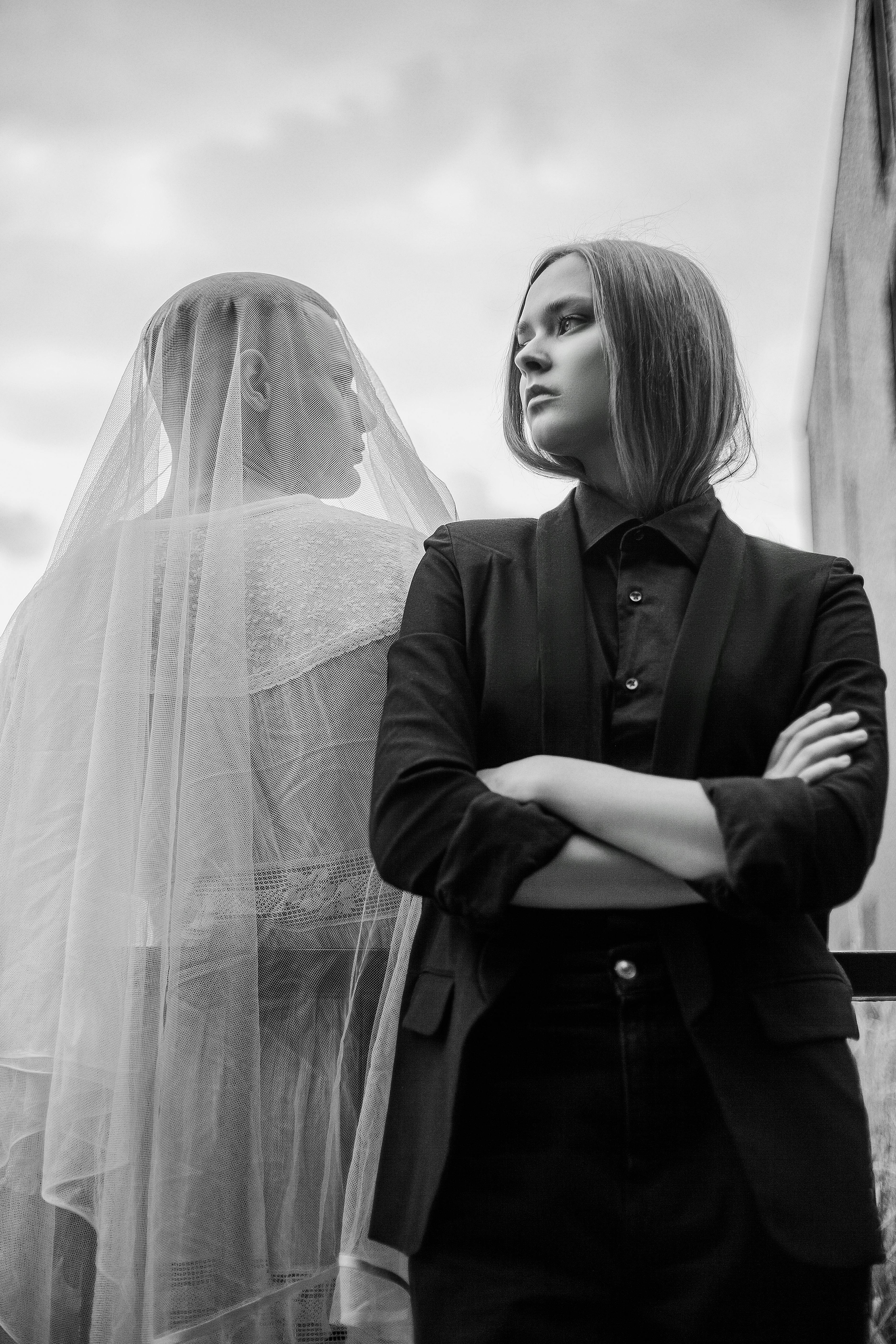woman in black suit and man in white veil