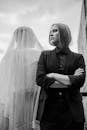 Woman in Black Suit and Man in White Veil