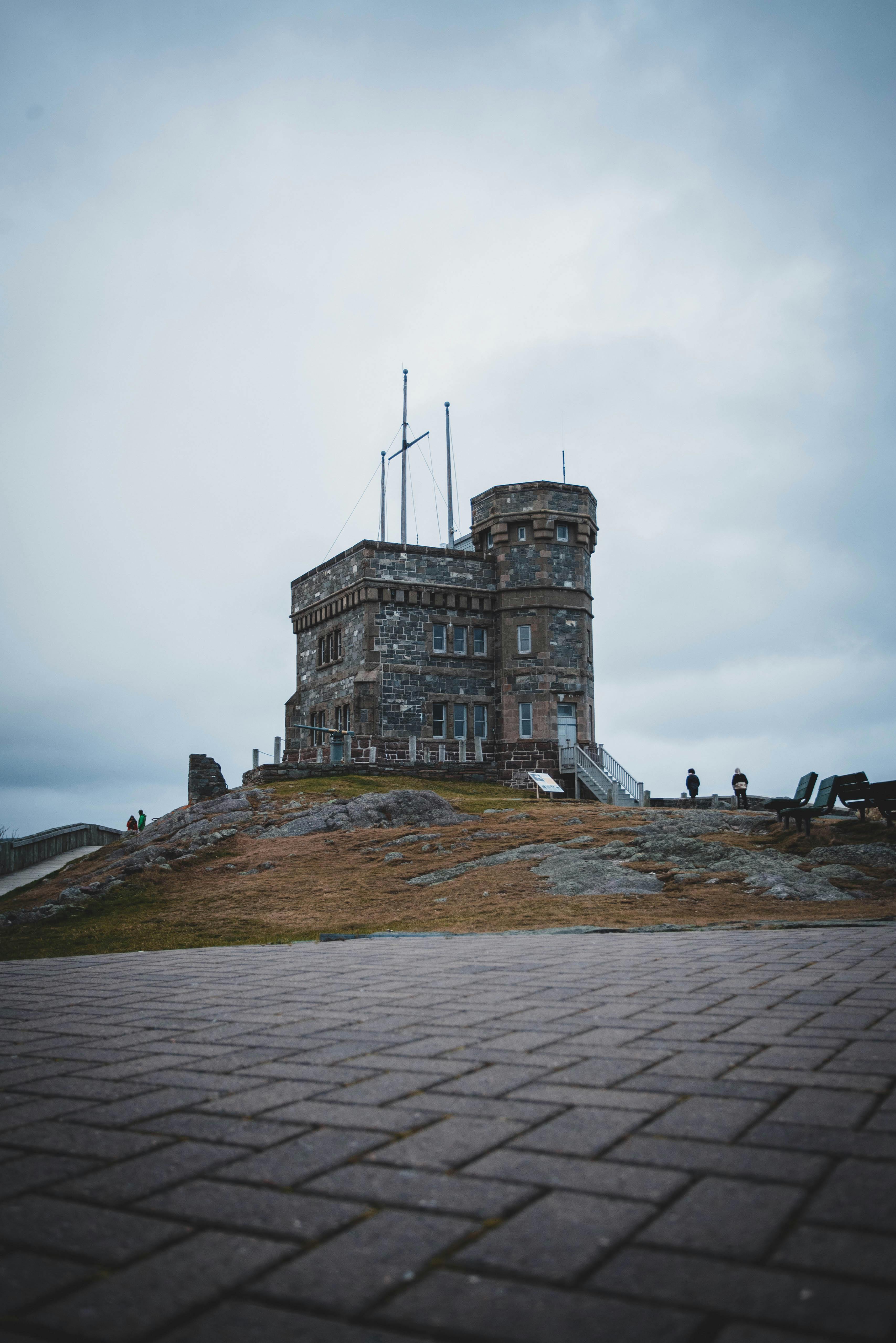 Historic tower on hill slope under sunset sky · Free Stock Photo