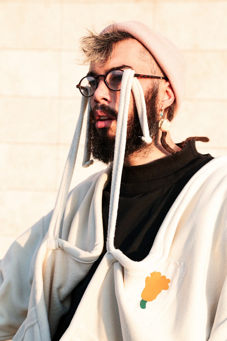 A Man's Jacket Hanging On His Eyeglasses