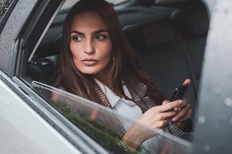 Portrait Of Brown Haired Woman Sitting In Car 
