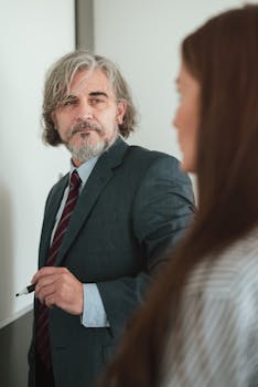 Businessman and woman discussing strategy in a modern office.