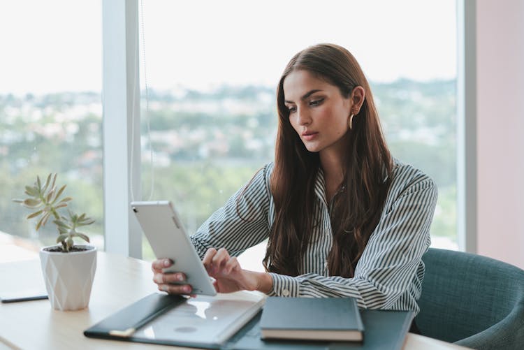 Portrait Of Woman In Shirt Working On Tablet