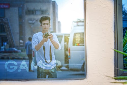 Man Wearing White Shirt And Holding Camera