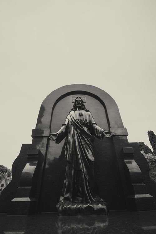 Free A striking black and white photo of a religious statue with open arms, low angle view. Stock Photo