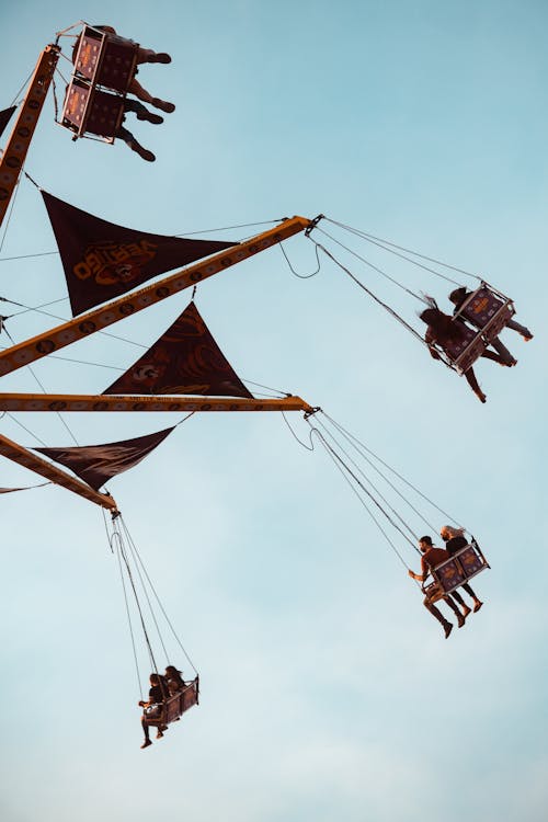 People Riding Swing Ride in Amusement Park
