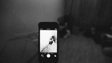Grayscale Photo of Iphone Displaying Spider Web