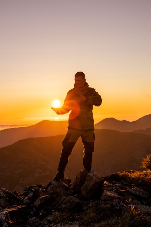 Free Man Posing on Top of a Mountain Stock Photo