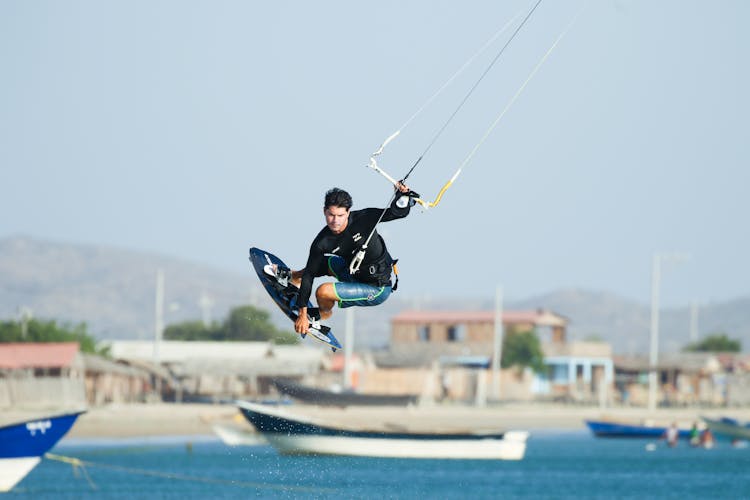 A Man Paragliding In The Beach