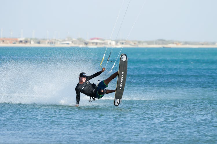 A Man Paragliding In The Beach