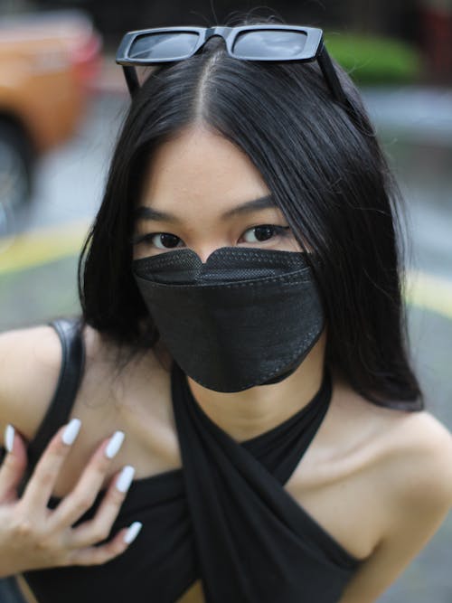 Free Close-Up Shot of a Pretty Woman in Black Halter Top with Face mask Stock Photo