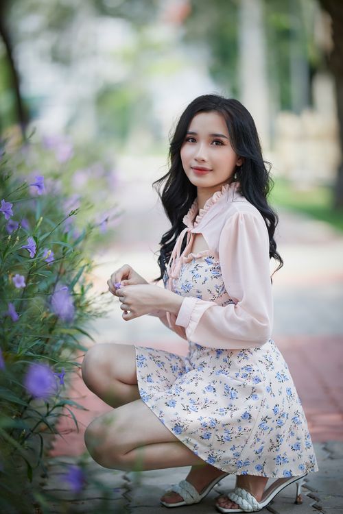 Free A beautiful woman posing with lavender flowers in an outdoor setting, exuding grace and charm. Stock Photo