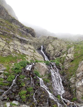 Breathtaking view of a waterfall cascading through rocky mountains in Romania.