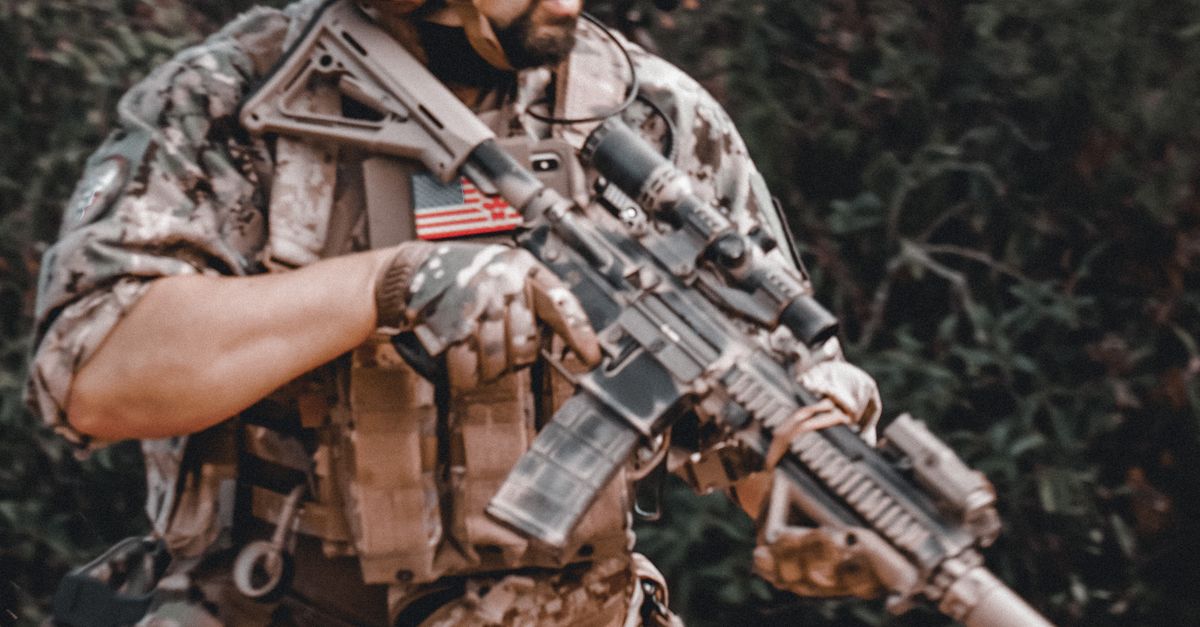 Man Carrying Assault Rifles Man Carrying a Rifle · Free Stock Photo