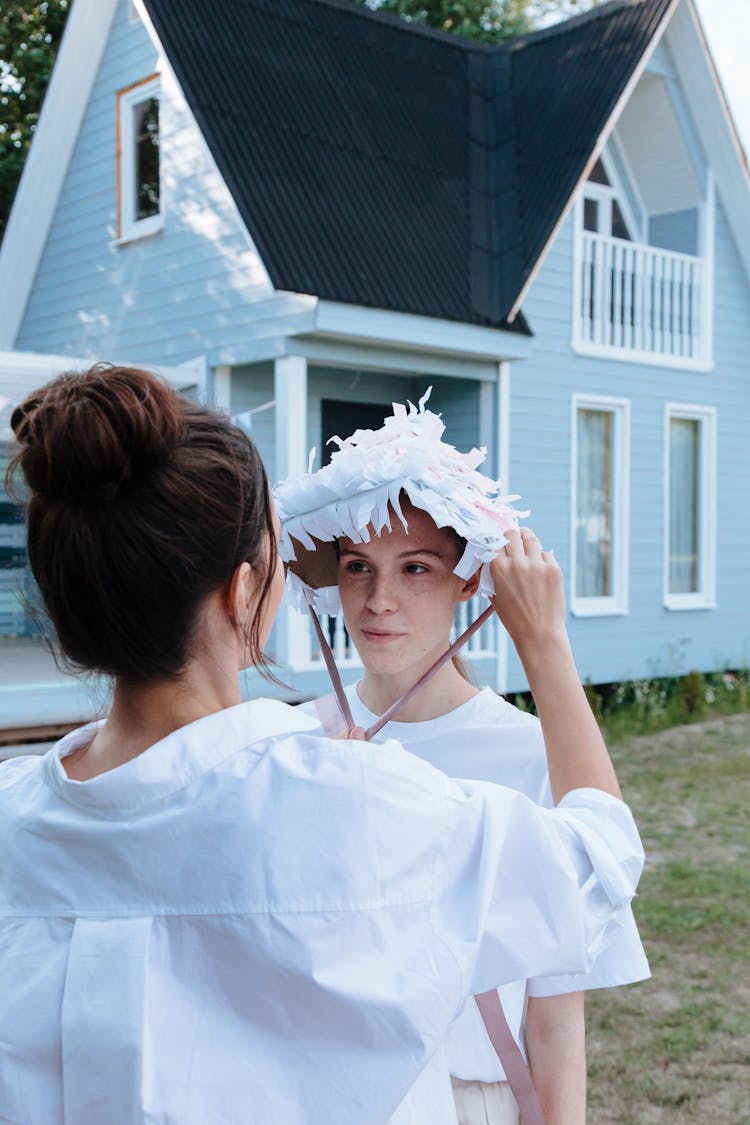 Women Putting On A Party Hat 