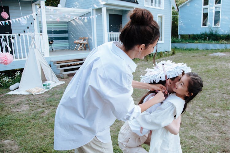 Women And Girl At Party In Backyard