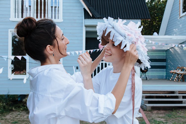 Women Trying On Party Hat