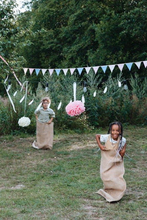 Girl and Boy Taking Part in Sack Race