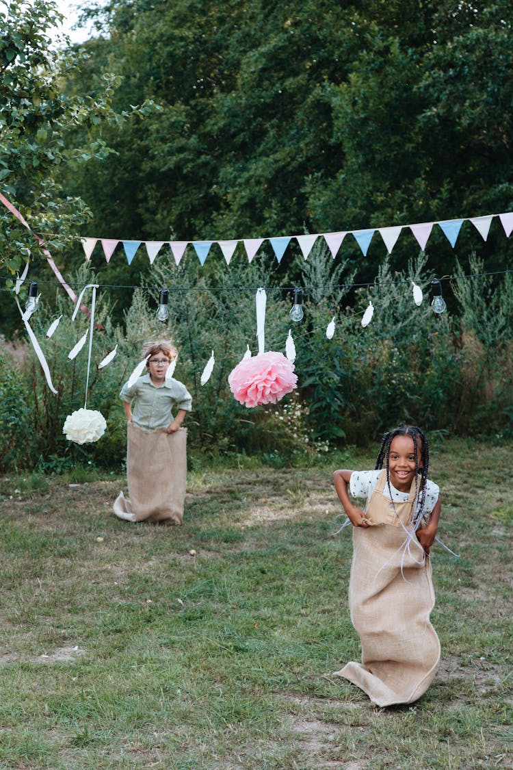 Girl And Boy Taking Part In Sack Race