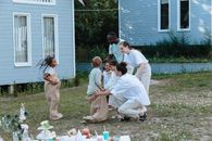 Children Playing Sack Race Outside the House with Their Family