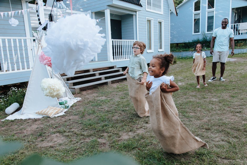 Kids having fun during an outdoor sack race at a backyard party with family.