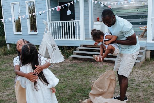 Free A joyful family day outdoors with children playing and parents enjoying the moment. Stock Photo