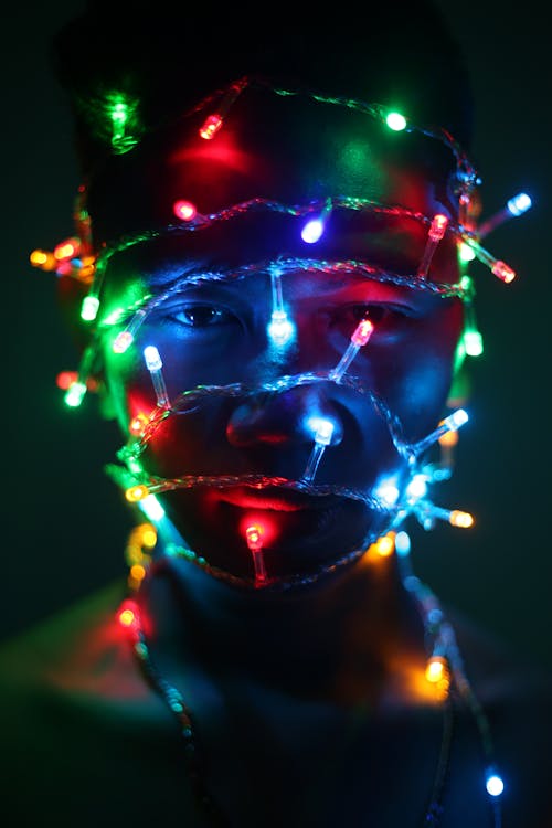 Free A Man Wrapped in Christmas Lights  Stock Photo