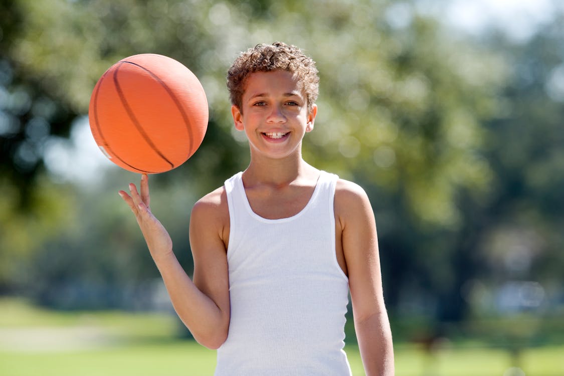 Selective Focus of a Boy Spinning the Ball · Free Stock Photo