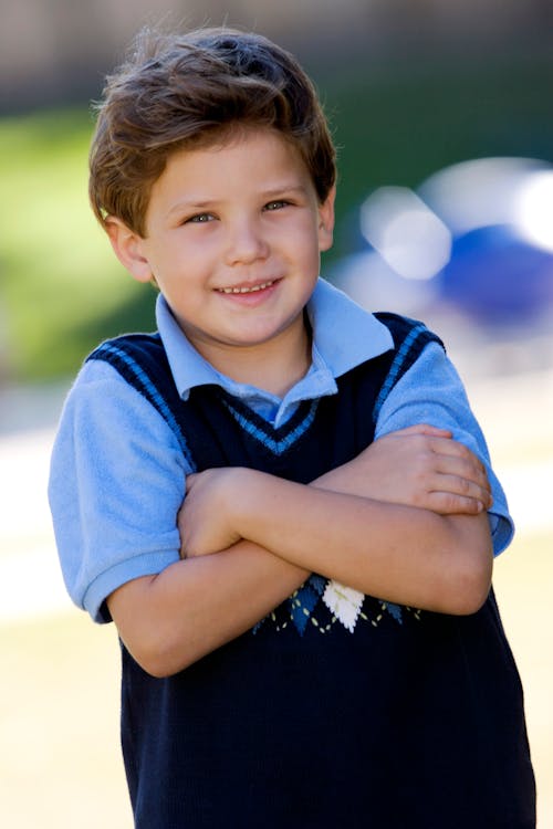 Free Boy in Blue Polo Shirt and Black Vest Stock Photo
