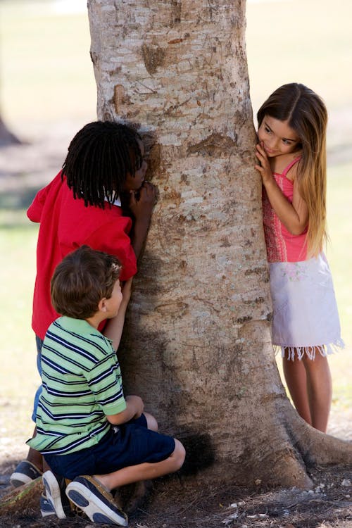 Girl Hiding Behind a Tree