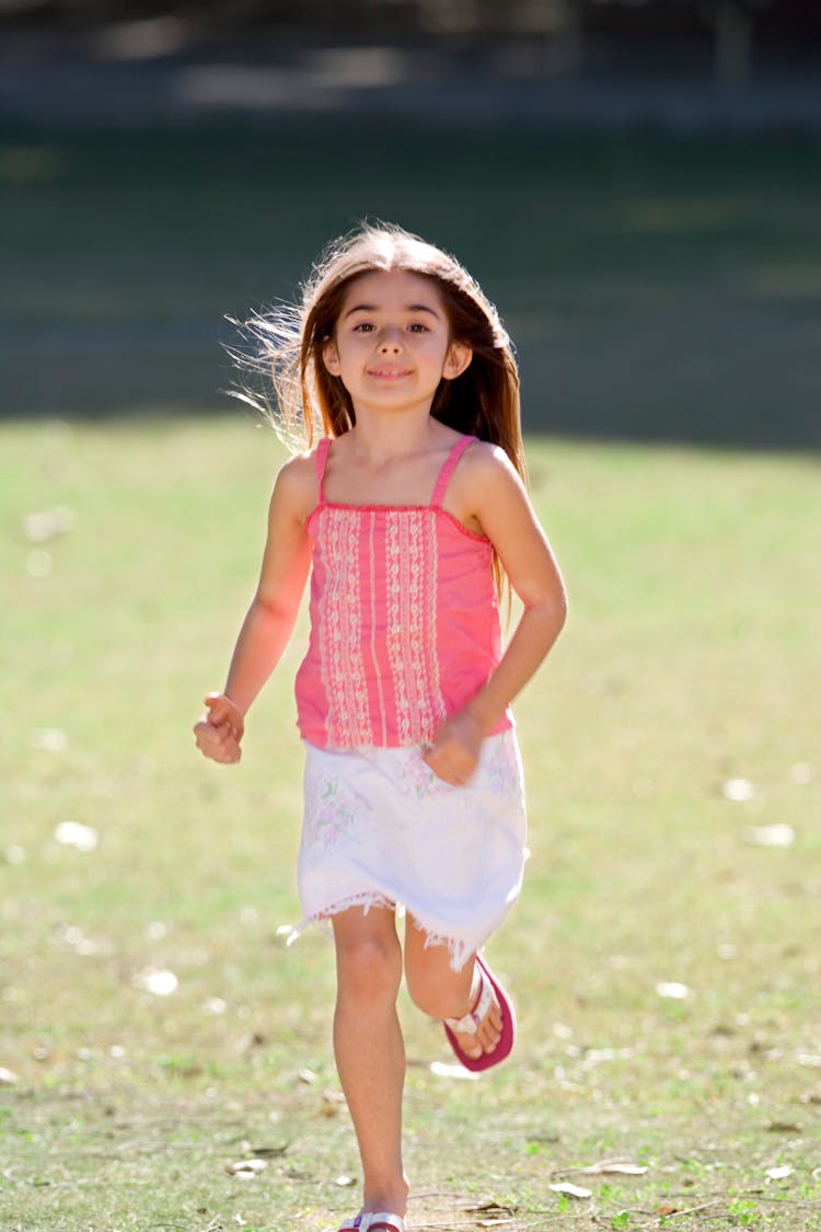 Selective Focus Of A Girl Running On The Ground