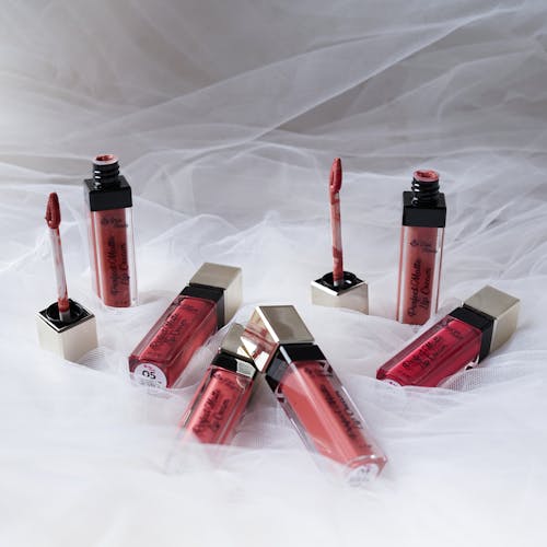Close-Up Shot of Red Lipsticks on a White Textile