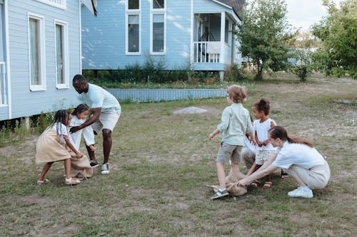 Free Family Playing in the Front Yard Stock Photo