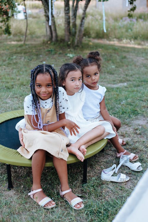 Little Girls Sitting on a Trampoline
