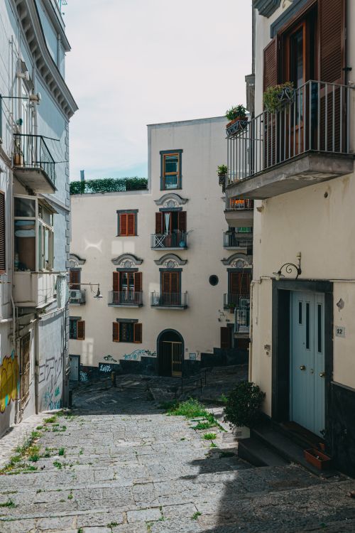 Free Picturesque alley in Naples showing historic architecture and vibrant atmosphere. Stock Photo
