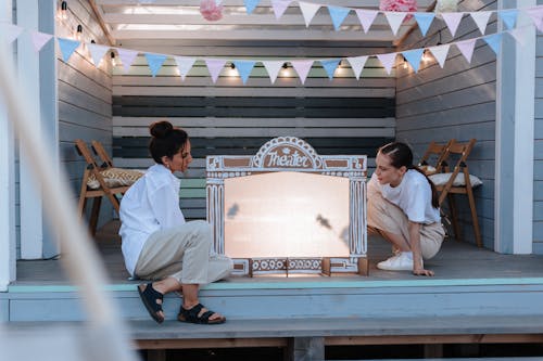 Women Performing Shadow Theatre in Backyard