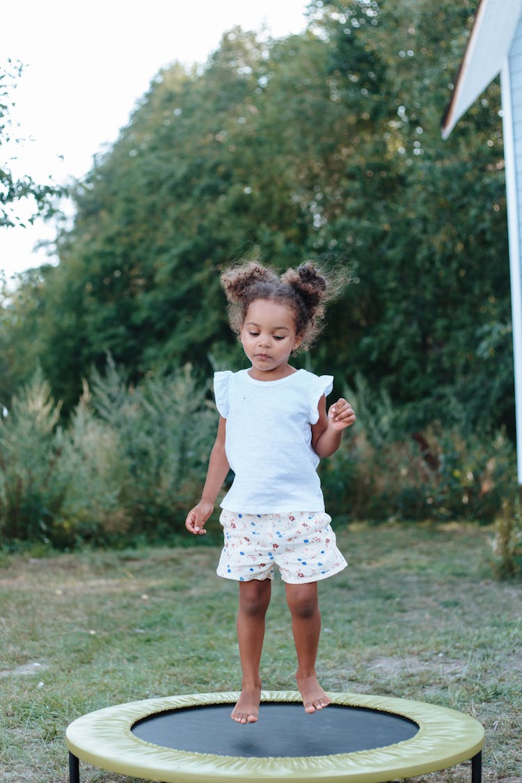 Little Girl Jumping On A Trampoline