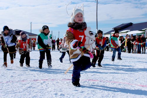 A Children Dancing Together on the Snow