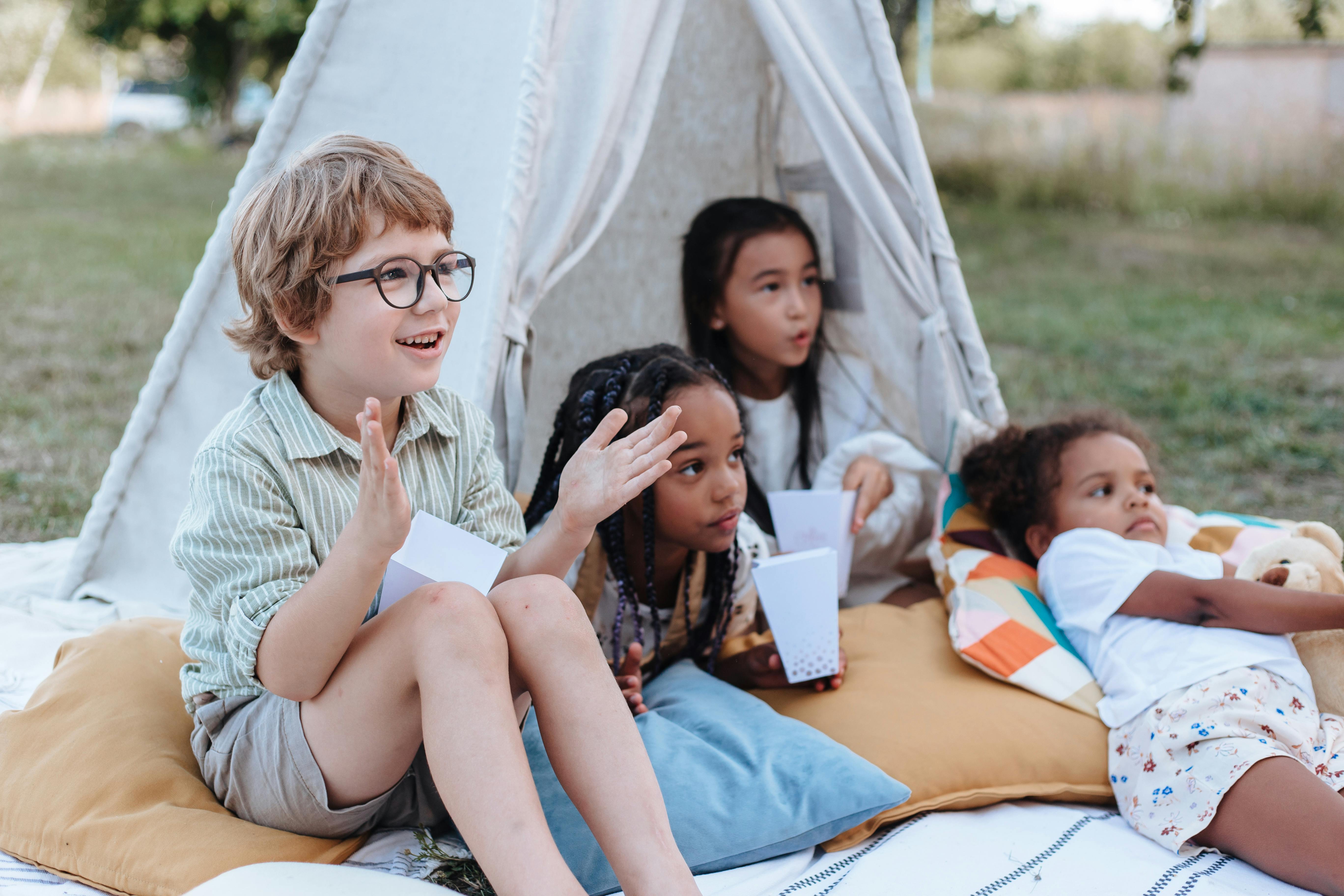 kids outside of teepee in backyard