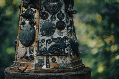Free Detailed close-up of a metallic sculpture with intricate designs in an outdoor setting. Stock Photo