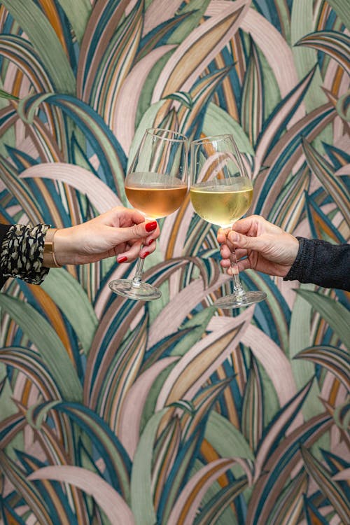 Free Two People Holding a Glass of Wine Stock Photo