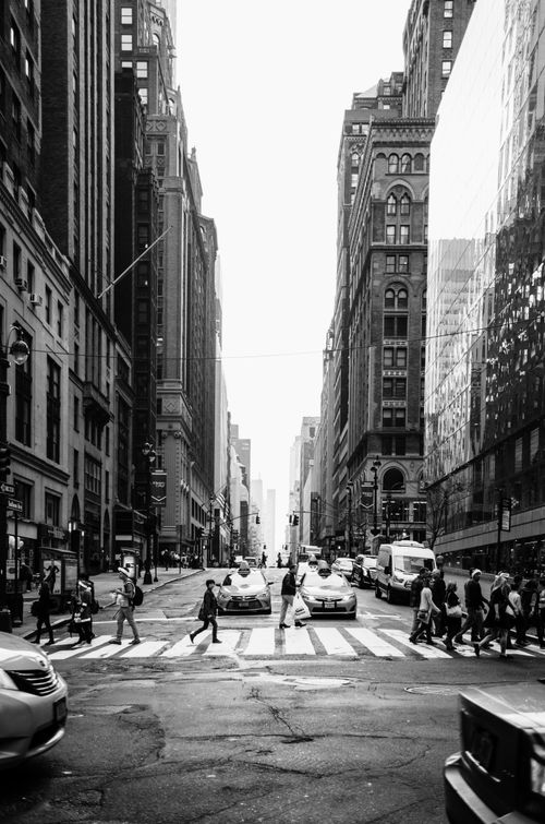 Free Dynamic black and white photo of a bustling New York City street with people and traffic. Stock Photo