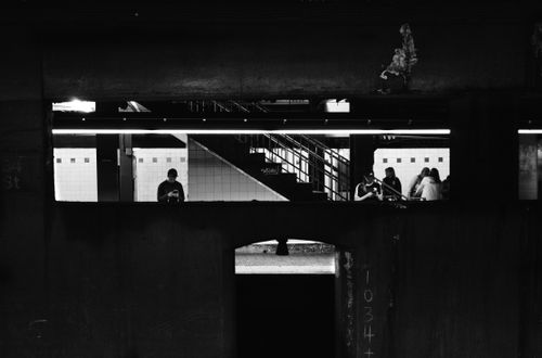 Free Black and white photo capturing people in a metropolitan subway station. Stock Photo