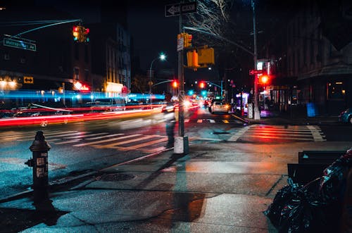 Cars Driving City Street at Night