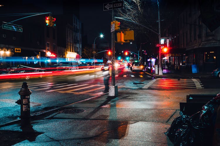 Cars Driving City Street At Night